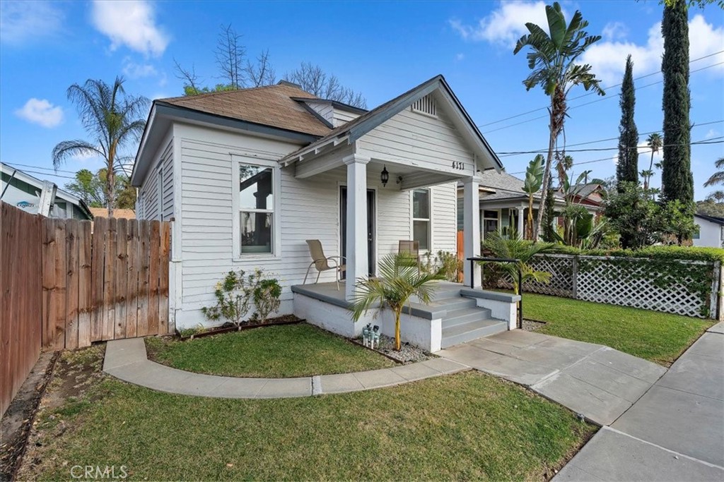 4171 9th Street Riverside, CA 92501 - Photo 2 of 19 a front view of a house with a yard