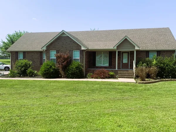 a front view of a house with a yard
