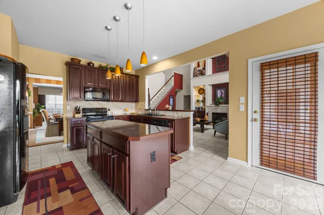 a kitchen with stainless steel appliances granite countertop a stove and a refrigerator