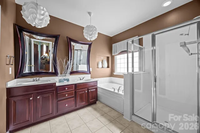 a spacious bathroom with a granite countertop sink a mirror and a vanity