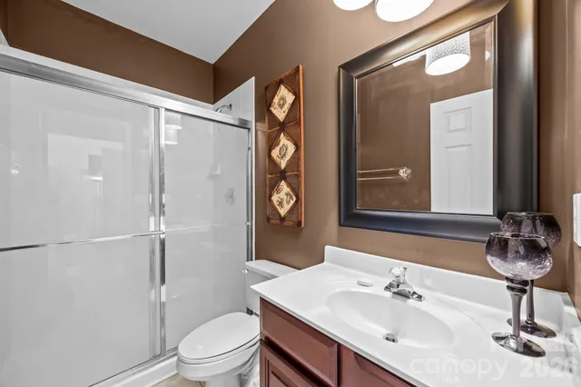 a bathroom with a toilet a sink and a mirror