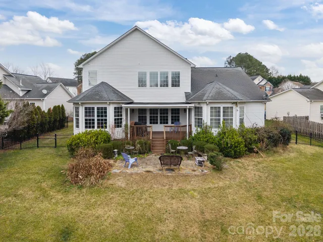 a front view of a house with swimming pool and furniture