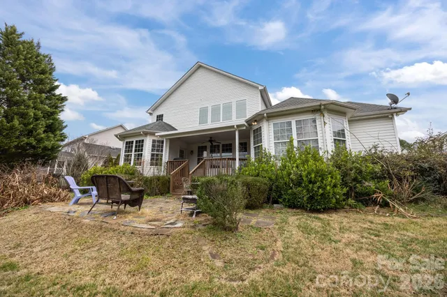 a front view of a house with yard and sitting area