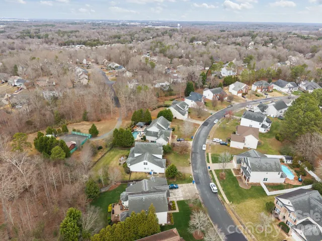 an aerial view of a house with a yard