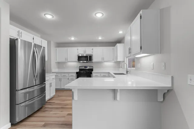 a bathroom with a sink a toilet and a large mirror