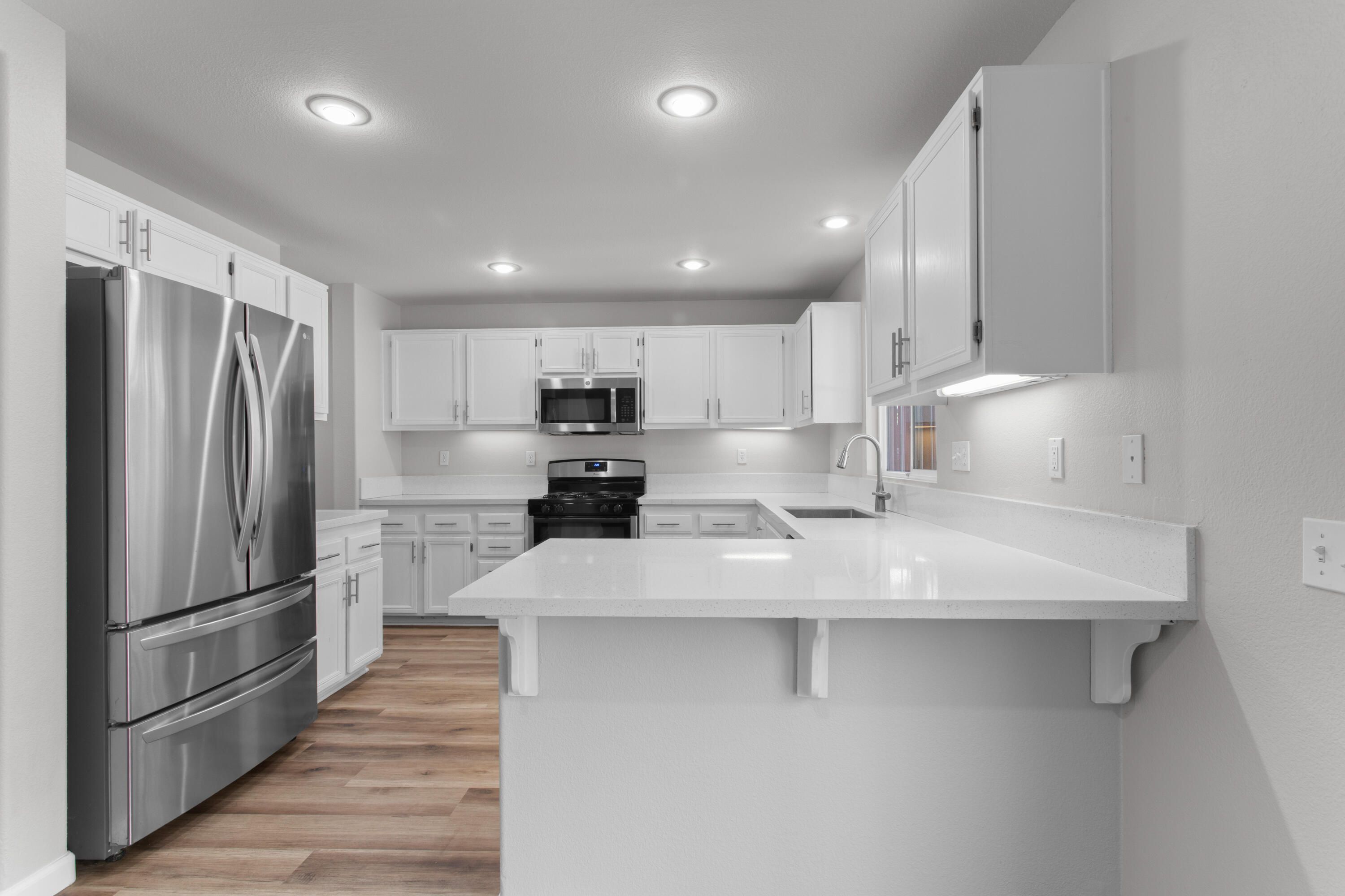 41970 Pacific Grove Way Temecula, CA 92591 - Photo 13 of 54 a kitchen with stainless steel appliances a refrigerator sink and microwave