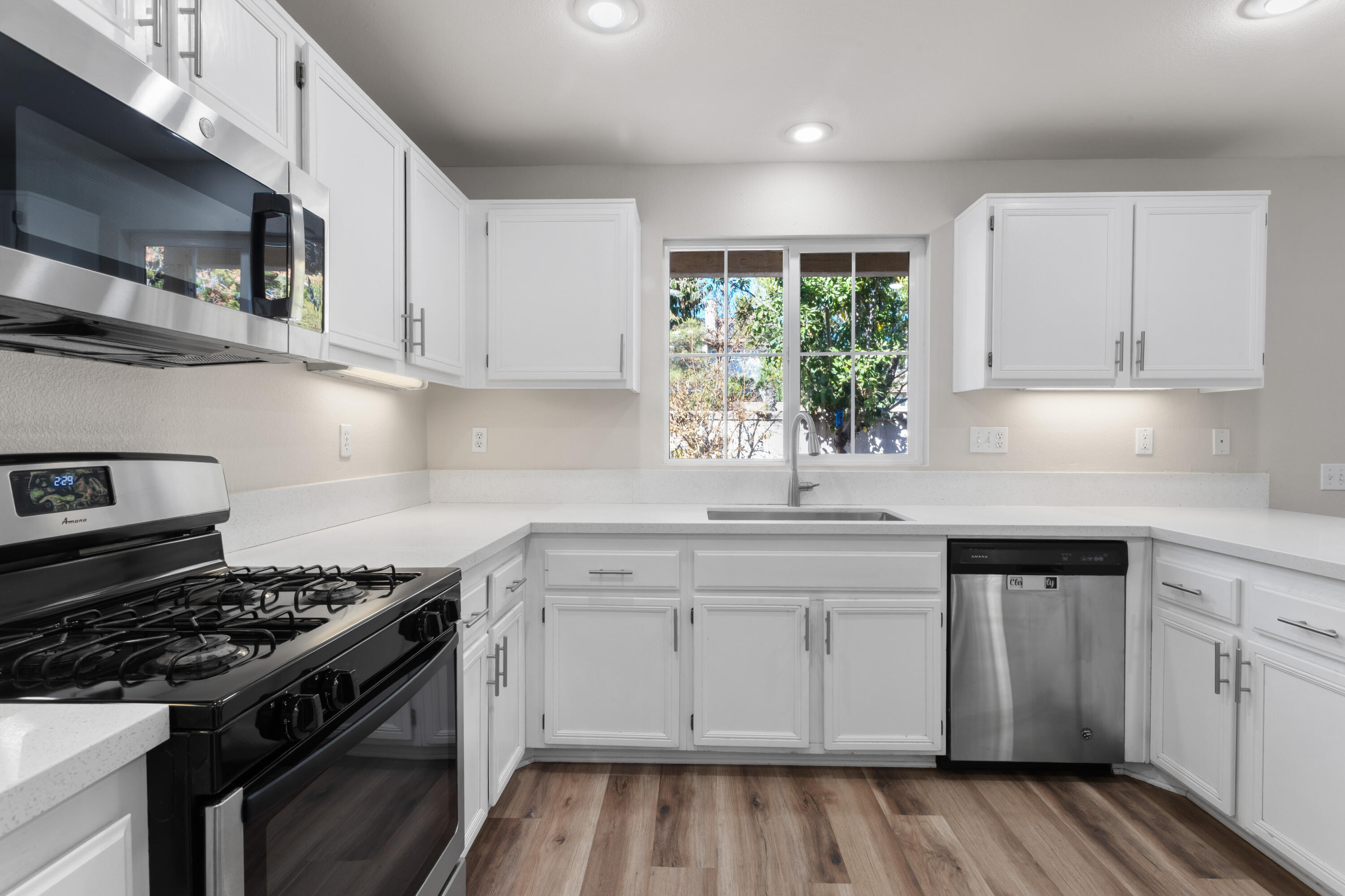 41970 Pacific Grove Way Temecula, CA 92591 - Photo 15 of 54 a kitchen with cabinets appliances and a window