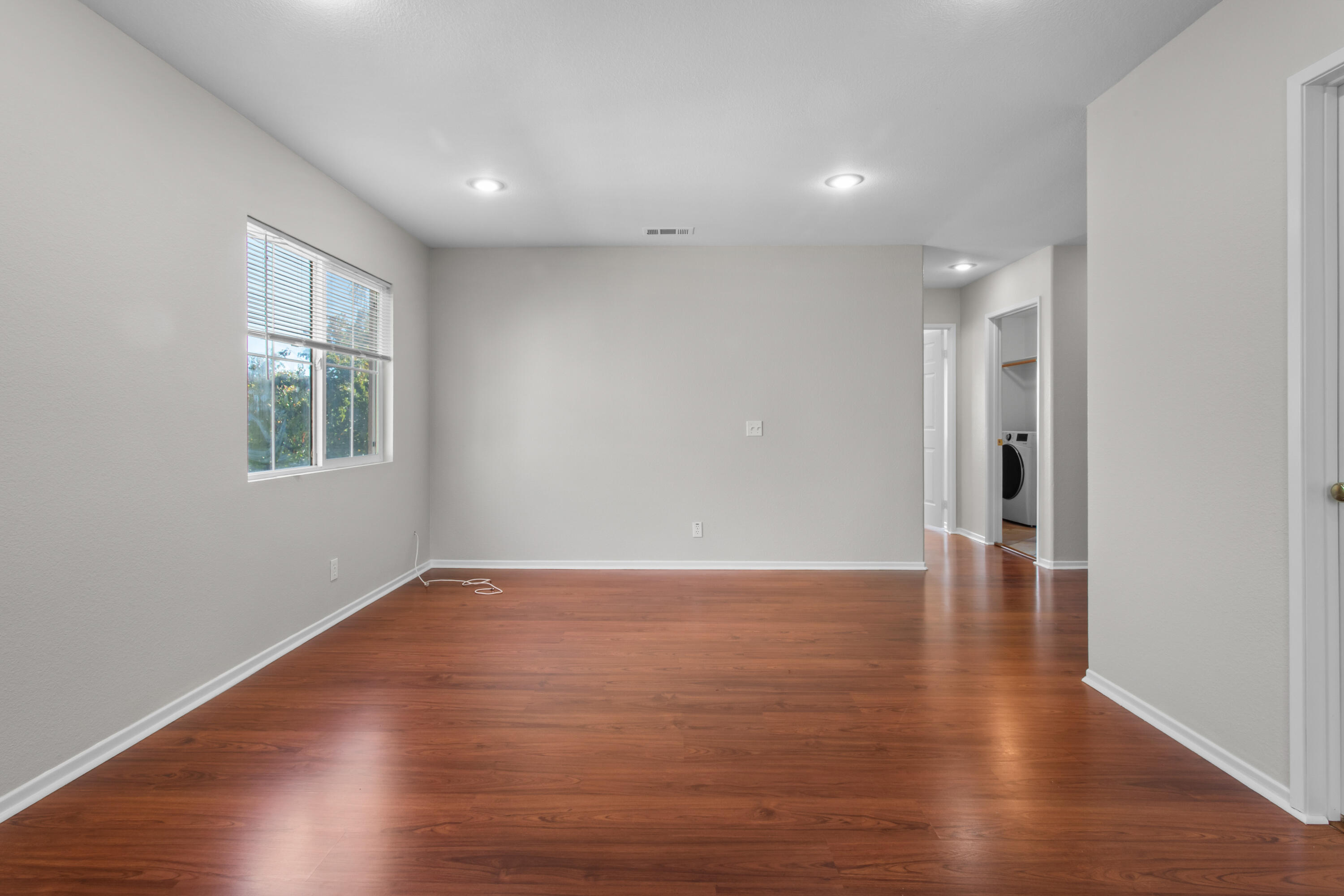41970 Pacific Grove Way Temecula, CA 92591 - Photo 22 of 54 a view of an empty room with wooden floor and a window