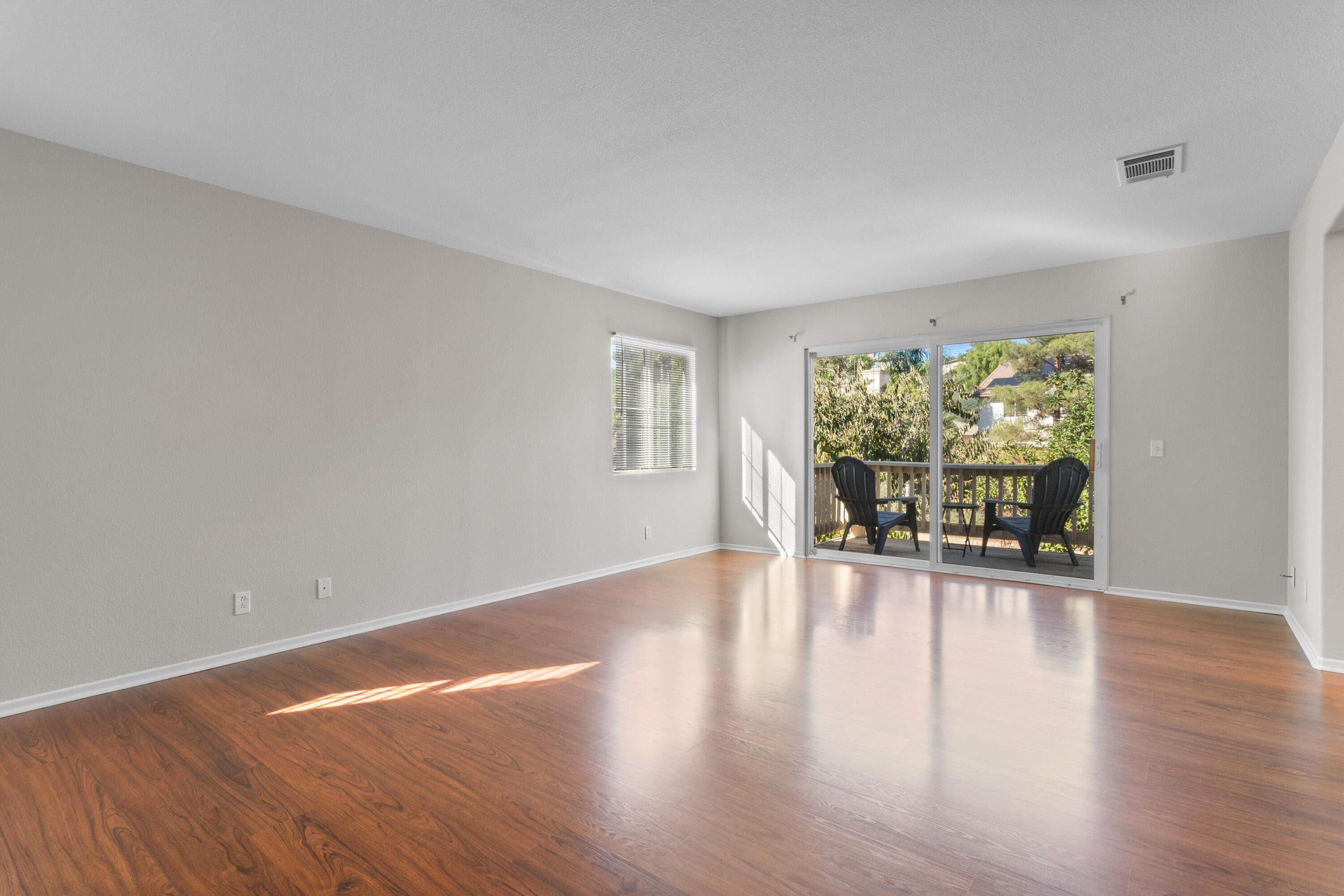 41970 Pacific Grove Way Temecula, CA 92591 - Photo 26 of 54 a view of an empty room with wooden floor and a window