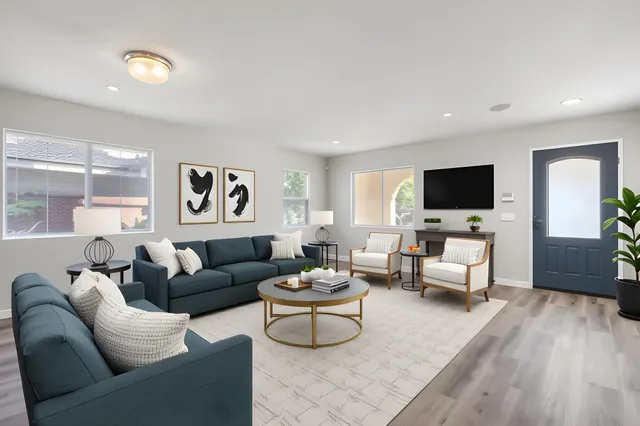 a view of empty room with wooden floor and fireplace