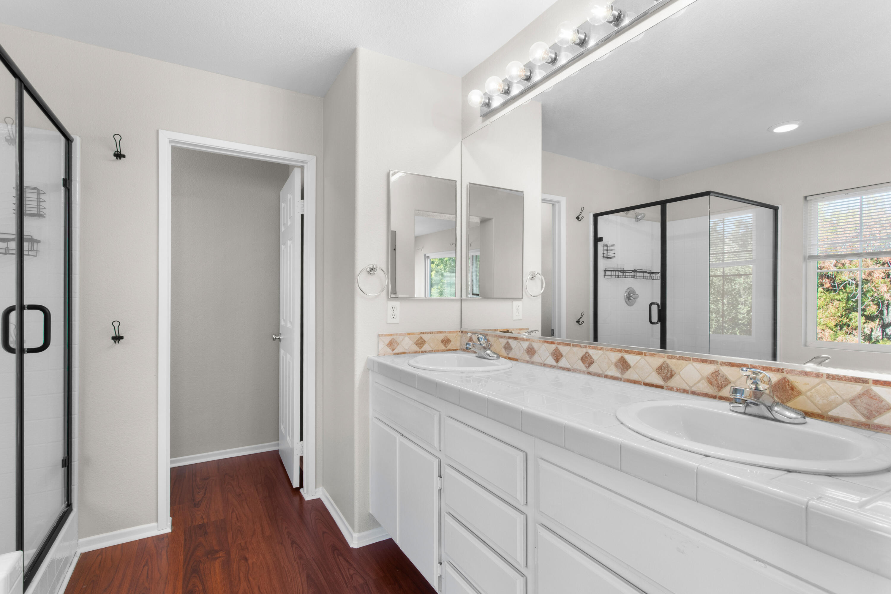 41970 Pacific Grove Way Temecula, CA 92591 - Photo 31 of 54 a bathroom with a double vanity sink mirror and shower