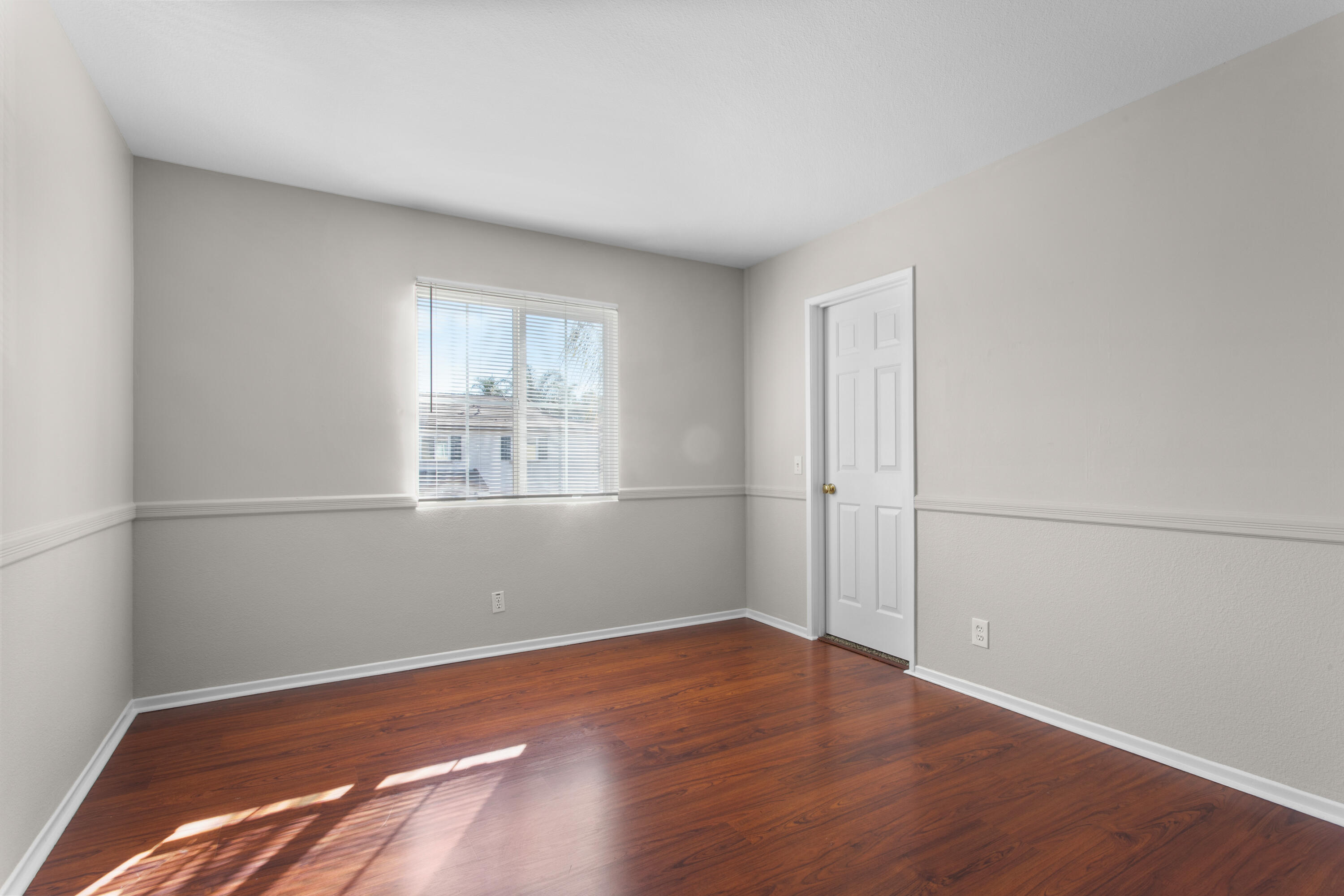 41970 Pacific Grove Way Temecula, CA 92591 - Photo 34 of 54 an empty room with wooden floor and windows