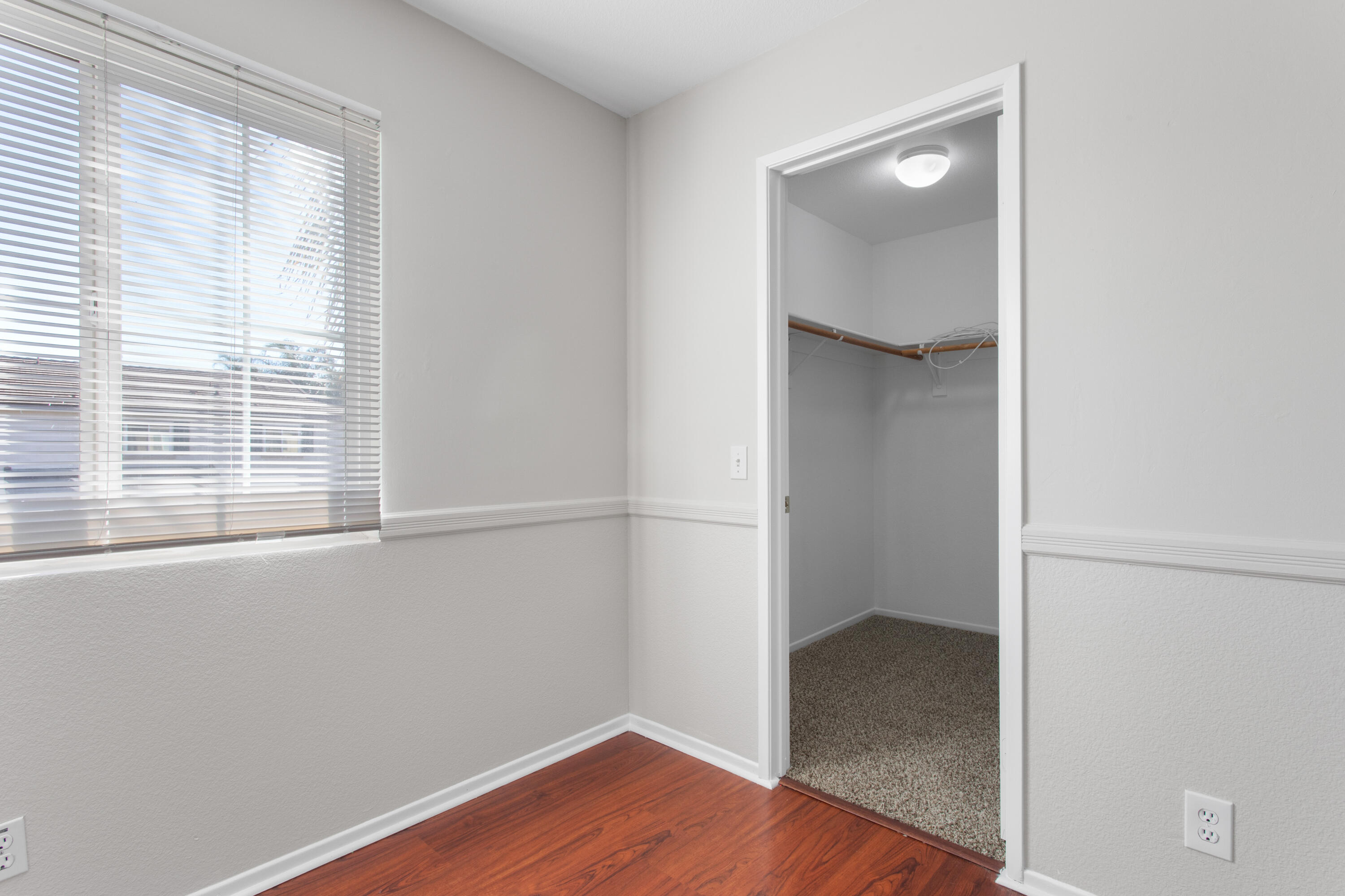 41970 Pacific Grove Way Temecula, CA 92591 - Photo 37 of 54 an empty room with wooden floor and windows