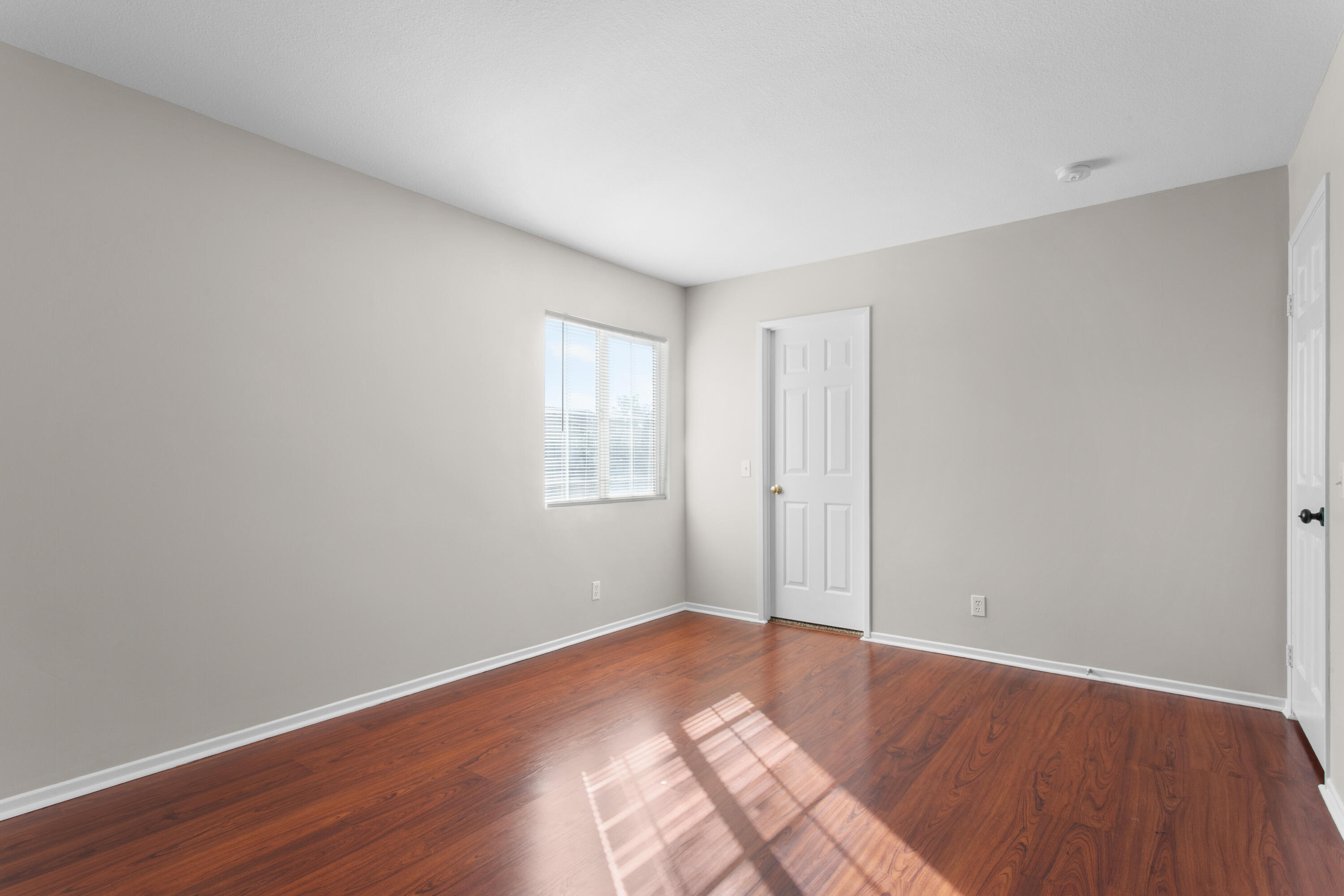 41970 Pacific Grove Way Temecula, CA 92591 - Photo 45 of 54 a view of an empty room with wooden floor and a window