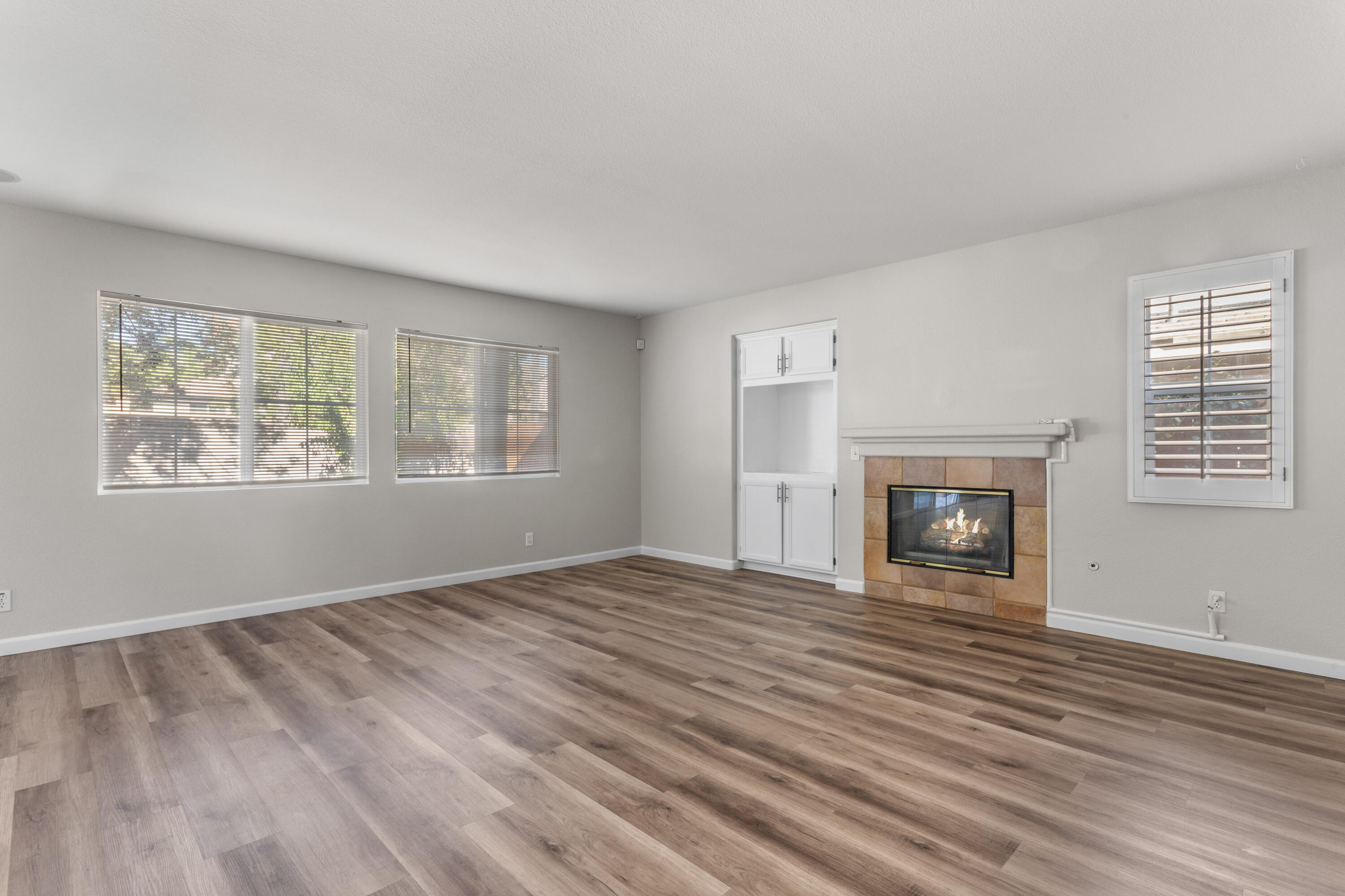 41970 Pacific Grove Way Temecula, CA 92591 - Photo 7 of 54 a view of empty room with fireplace and wooden floor