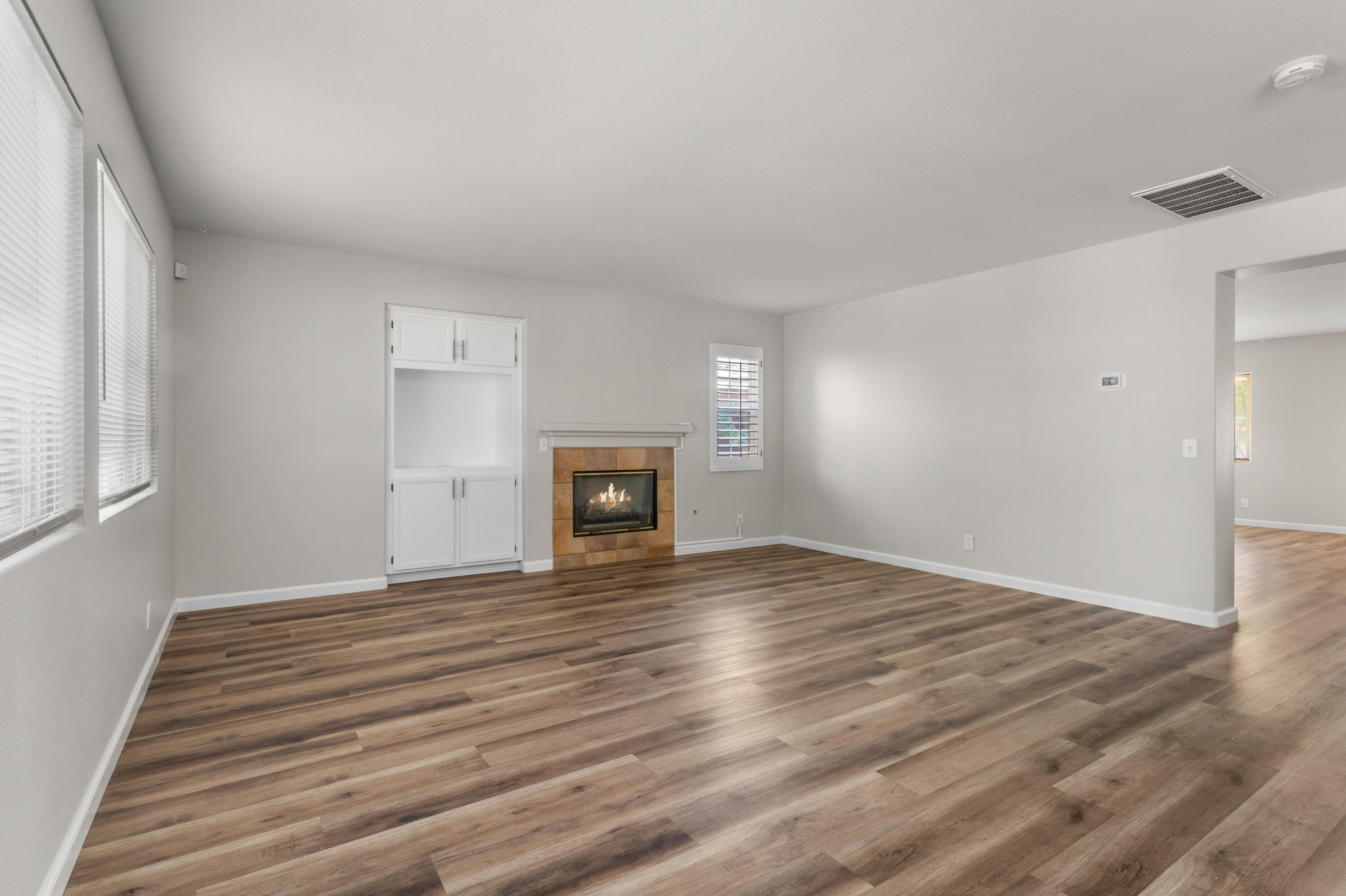 41970 Pacific Grove Way Temecula, CA 92591 - Photo 8 of 54 a view of empty room with wooden floor and fireplace