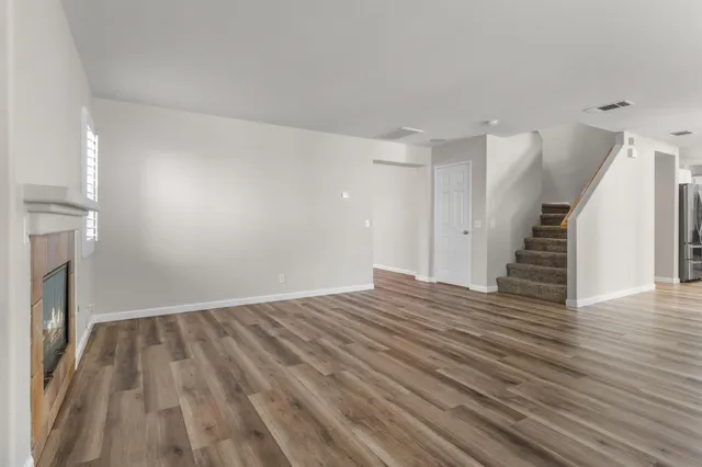 a view of a porch with furniture and wooden floor