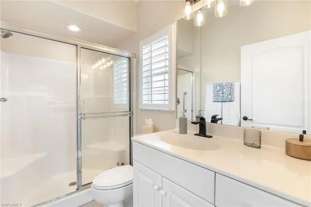 a bathroom with a double vanity sink toilet and shower