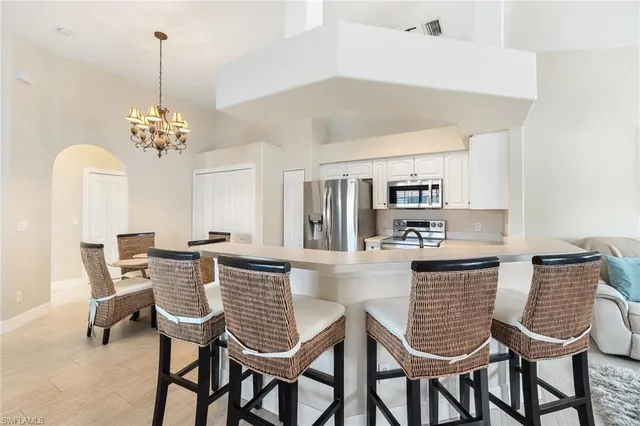 a view of a dining room with furniture and chandelier