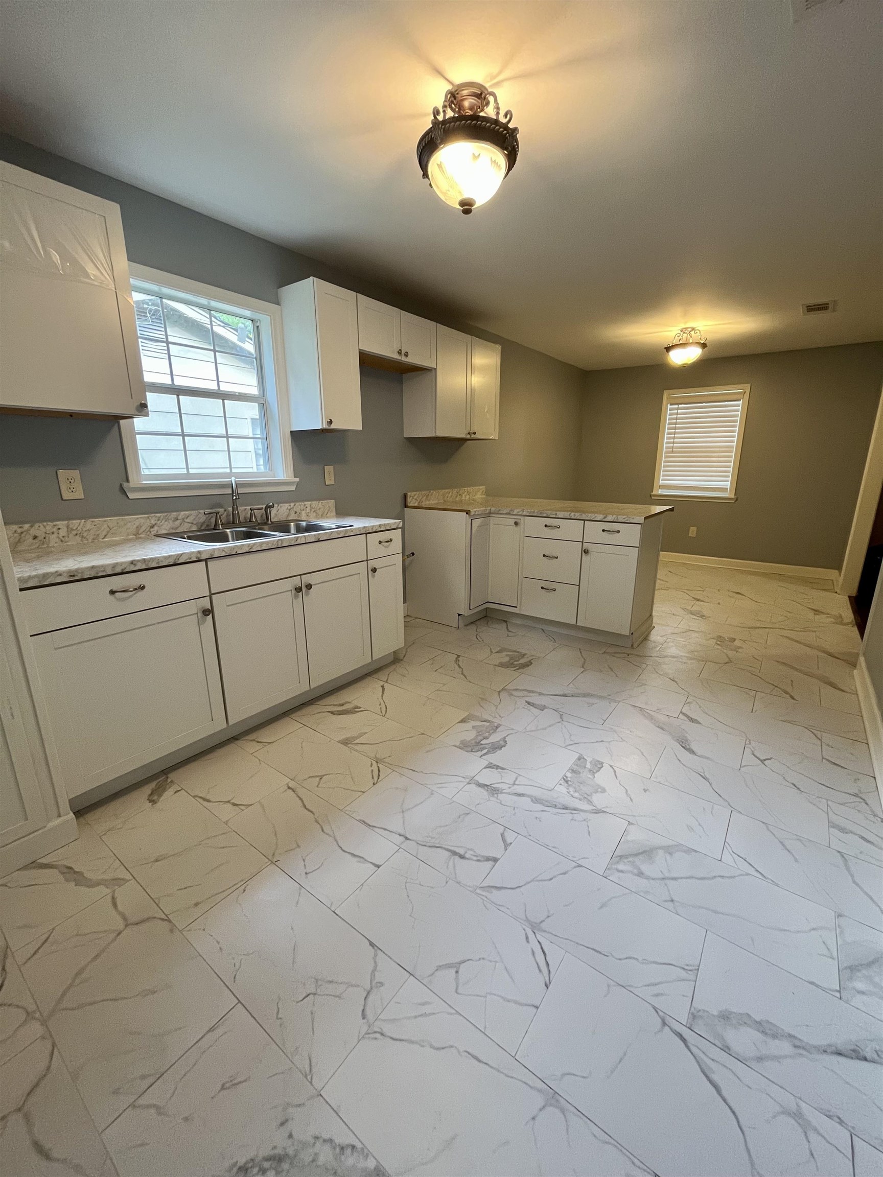 1204 Margaret Road Memphis, TN 38109 - Photo 4 of 25 a large white kitchen with a sink and cabinets