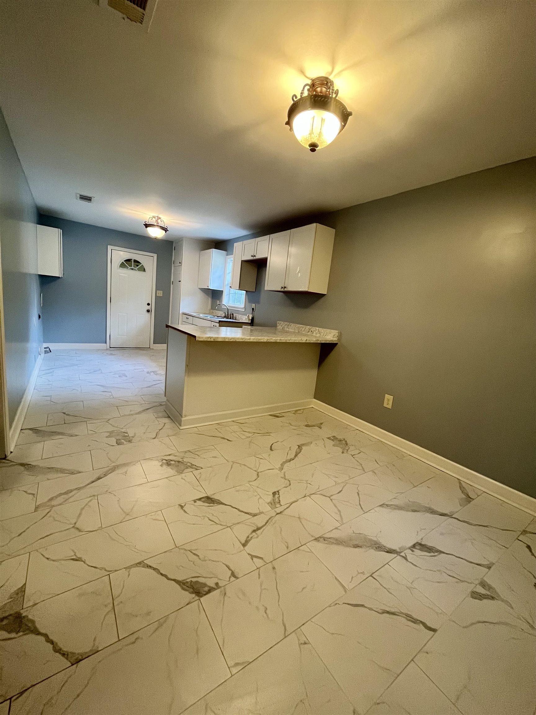 1204 Margaret Road Memphis, TN 38109 - Photo 5 of 25 a bedroom with a bed and a chandelier
