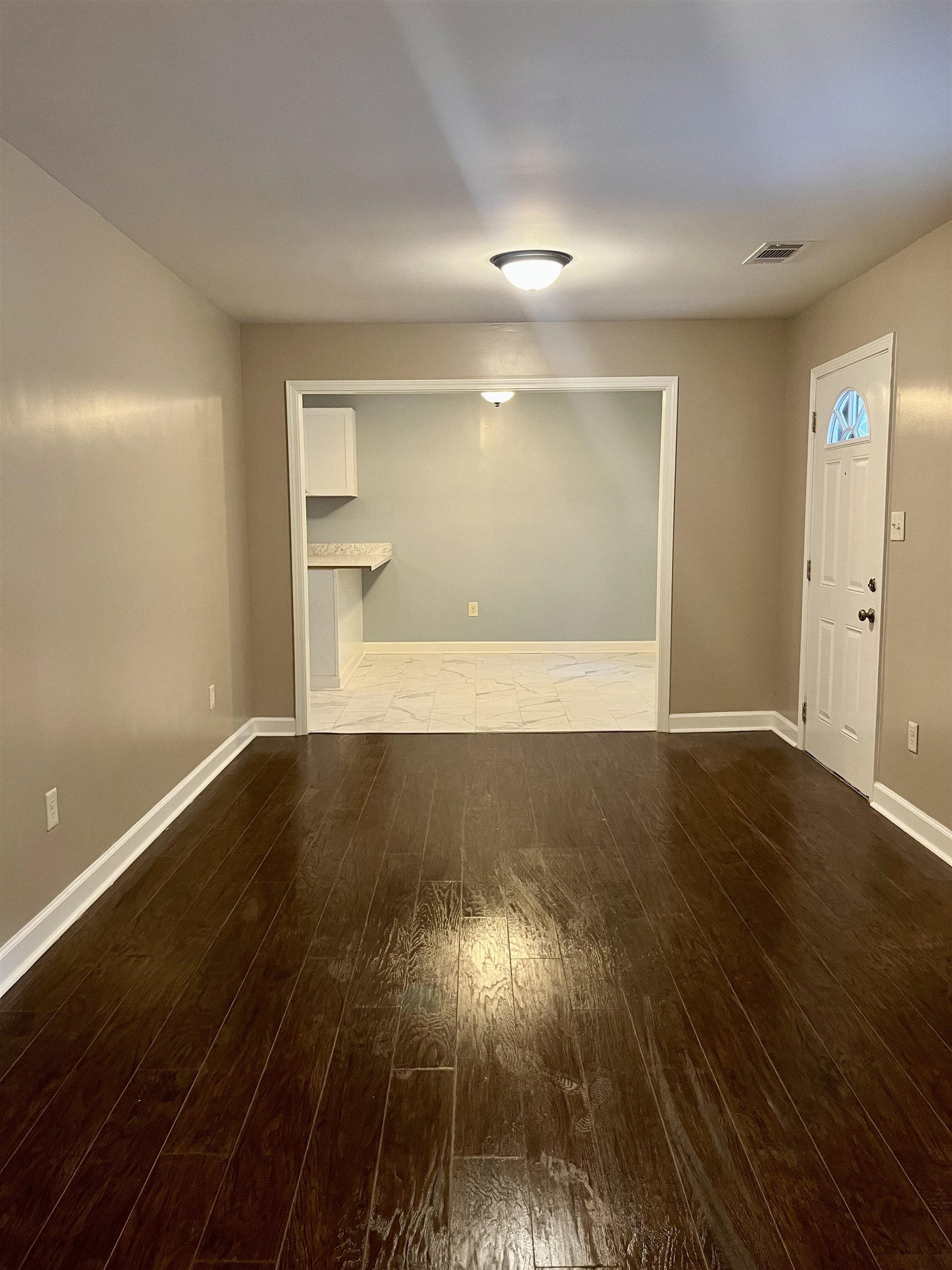 1204 Margaret Road Memphis, TN 38109 - Photo 8 of 25 an empty room with wooden floor and windows