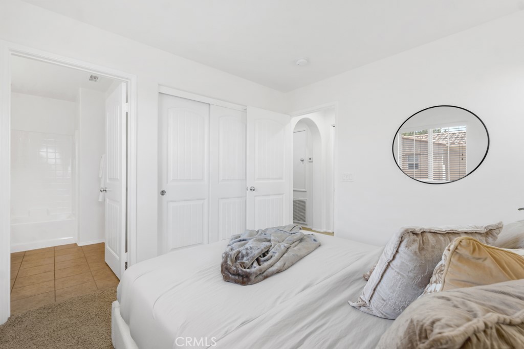 20317 Livorno Porter Ranch Porter Ranch, CA 91326 - Photo 22 of 33 a bedroom with bed and a couch