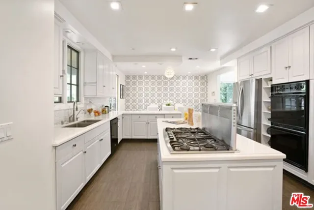 a kitchen with a stove a sink and a refrigerator