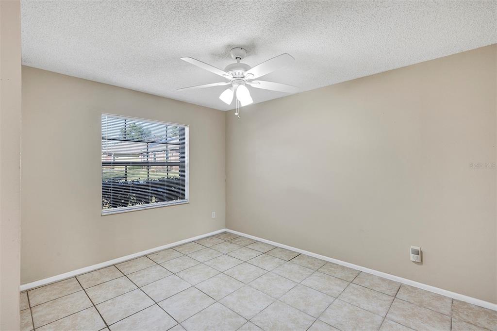 6701 Merlin Court Orlando, FL 32810 - Photo 11 of 54 an empty room with windows and fan