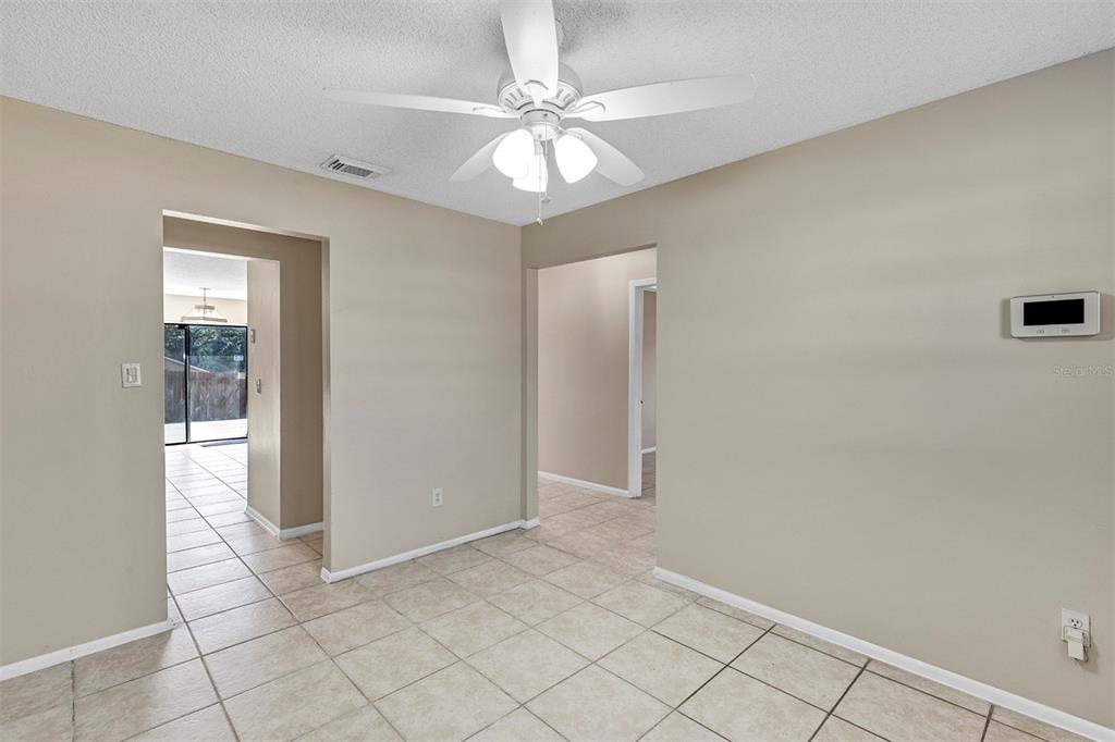 6701 Merlin Court Orlando, FL 32810 - Photo 13 of 54 wooden floor in an empty room with a window