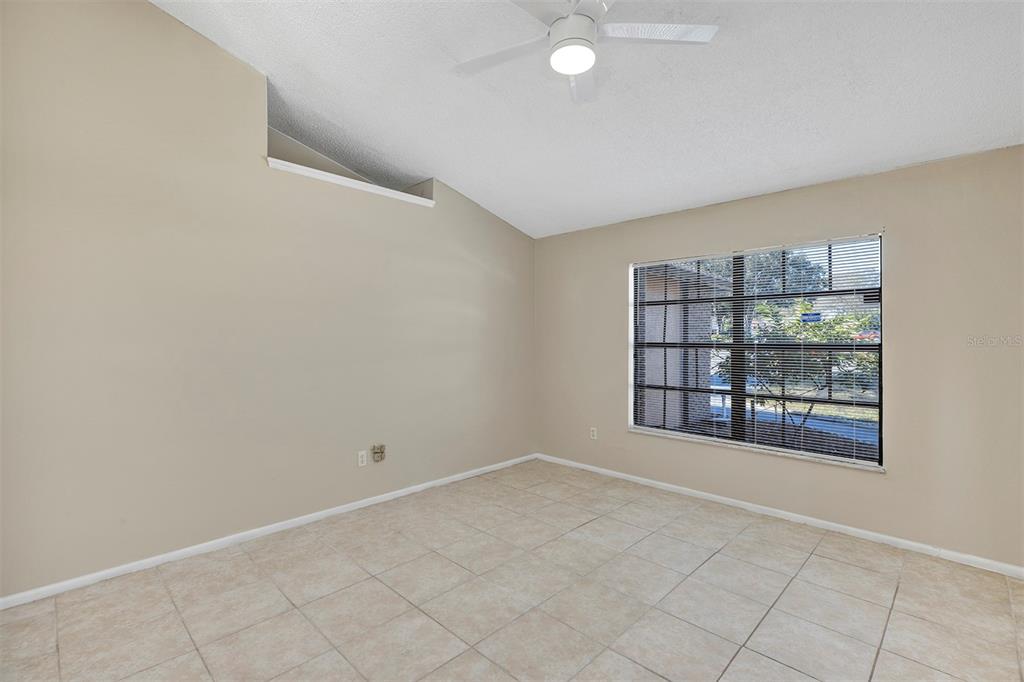 6701 Merlin Court Orlando, FL 32810 - Photo 16 of 54 wooden floor in an empty room with a window