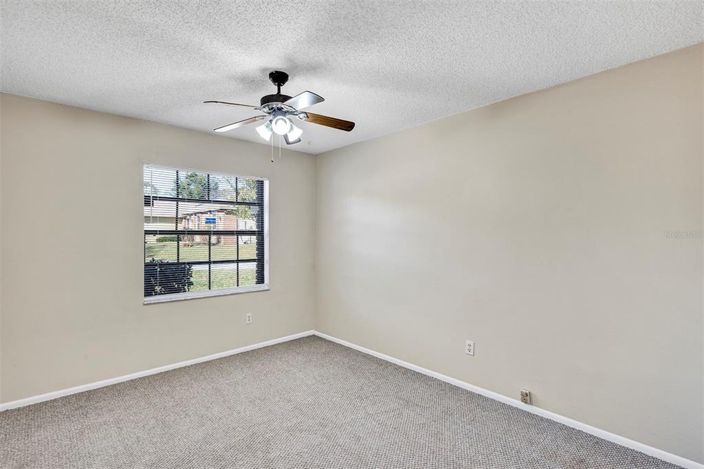 6701 Merlin Court Orlando, FL 32810 - Photo 20 of 54 an empty room with a window and ceiling fan