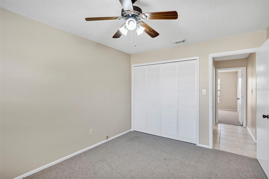 6701 Merlin Court Orlando, FL 32810 - Photo 21 of 54 an empty room with a chandelier fan