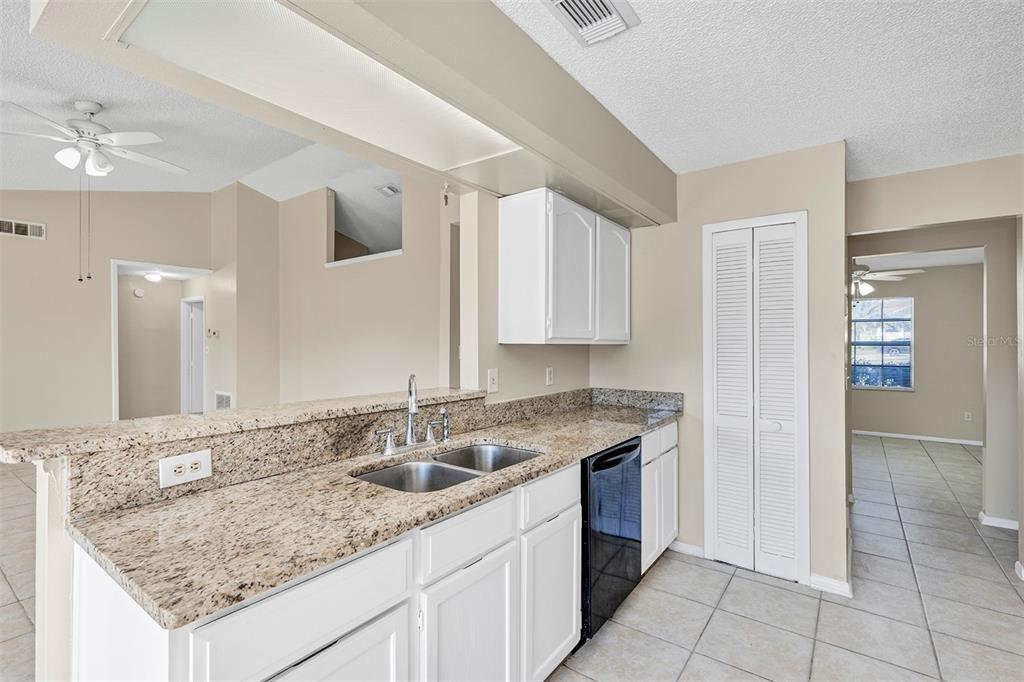 6701 Merlin Court Orlando, FL 32810 - Photo 27 of 54 a kitchen with a sink stove and cabinets