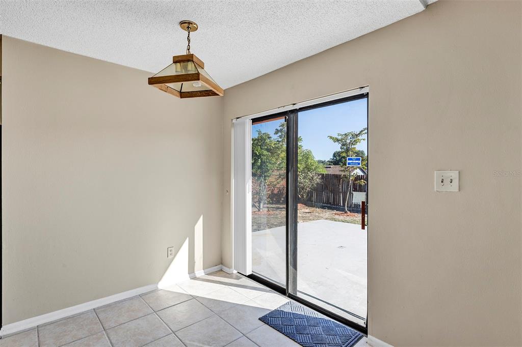 6701 Merlin Court Orlando, FL 32810 - Photo 29 of 54 a view of a livingroom with wooden floor and a ceiling fan
