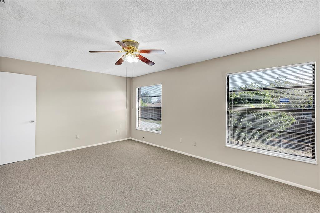 6701 Merlin Court Orlando, FL 32810 - Photo 39 of 54 a view of room with a ceiling fan and window
