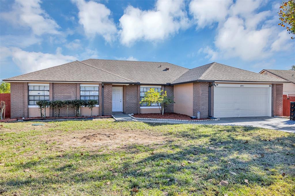 6701 Merlin Court Orlando, FL 32810 - Photo 4 of 54 a house with green field in front of it