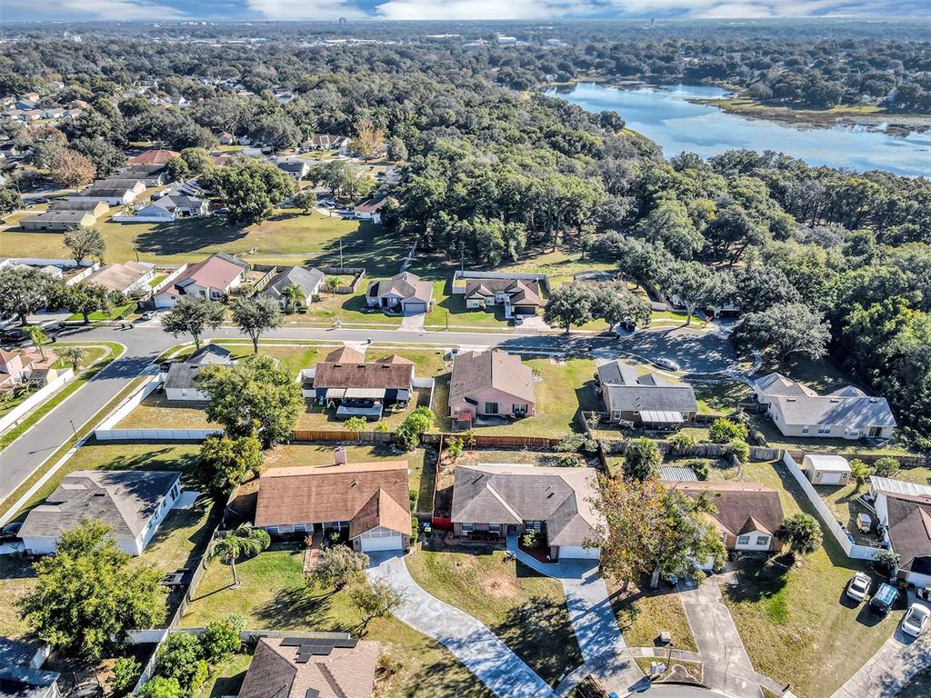 6701 Merlin Court Orlando, FL 32810 - Photo 52 of 54 an aerial view of a houses with a lake view