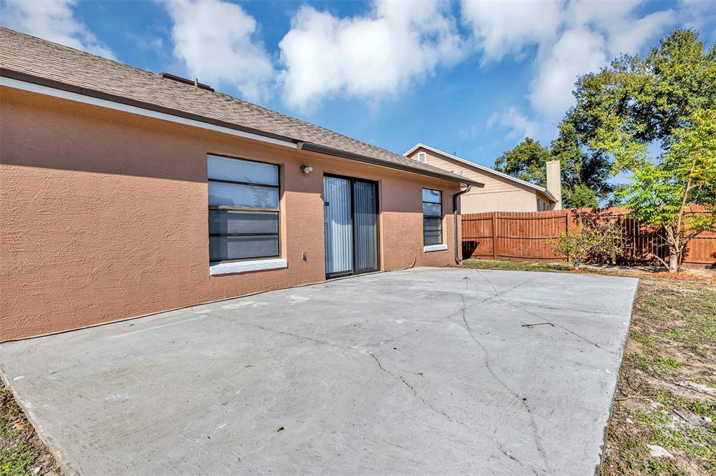 6701 Merlin Court Orlando, FL 32810 - Photo 8 of 54 a view of a house with a yard