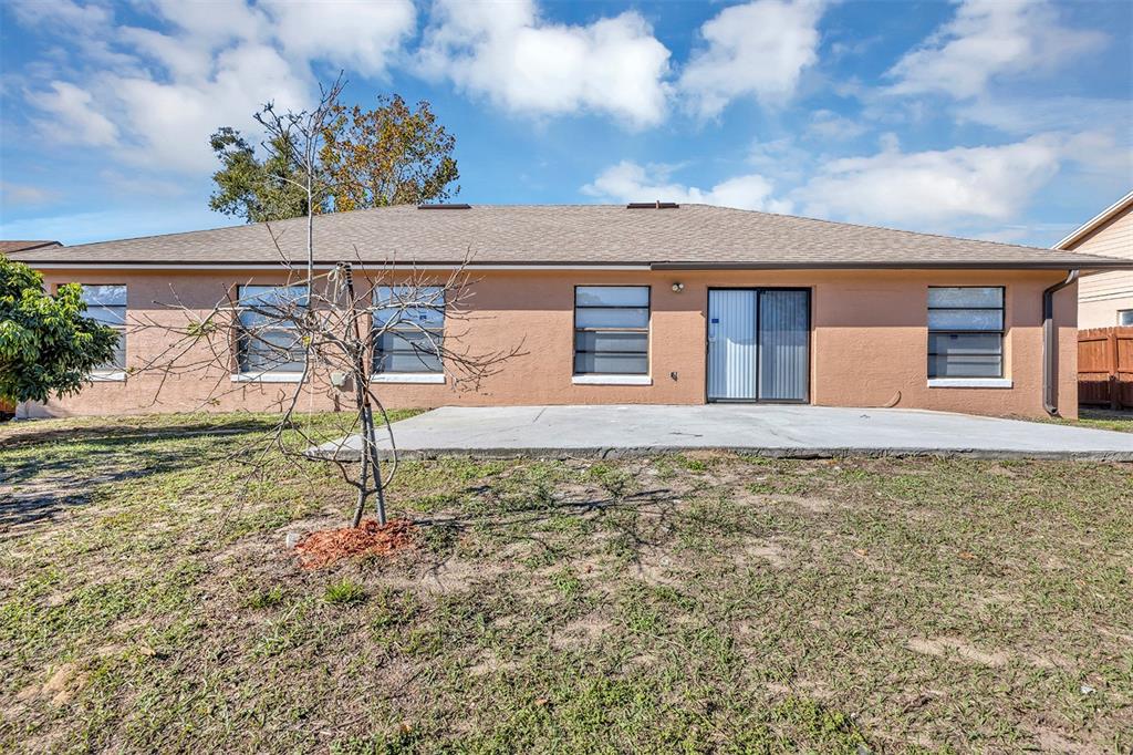 6701 Merlin Court Orlando, FL 32810 - Photo 9 of 54 a house view with a garden space