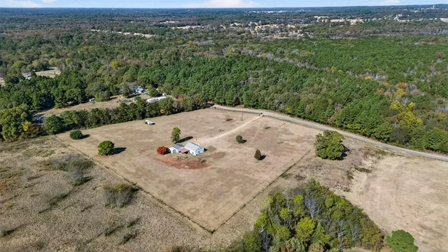 an aerial view of a house with yard