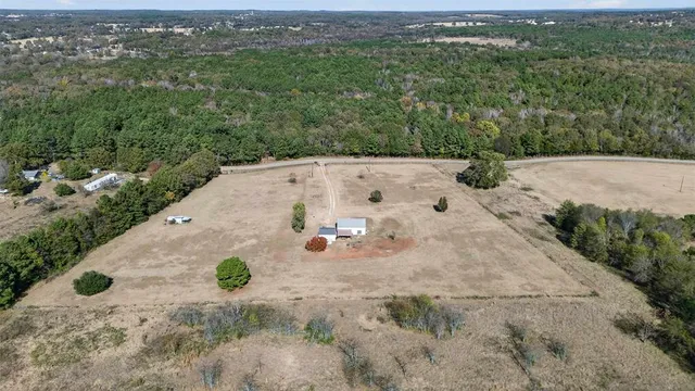 an aerial view of a house with yard