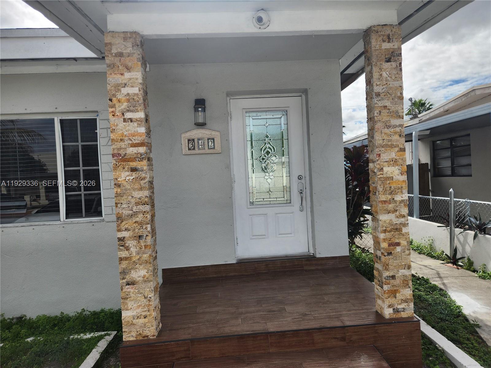 342 East 46th Street, Unit 1 Hialeah, FL 33013 - Photo 2 of 26 a front view of a house with a yard