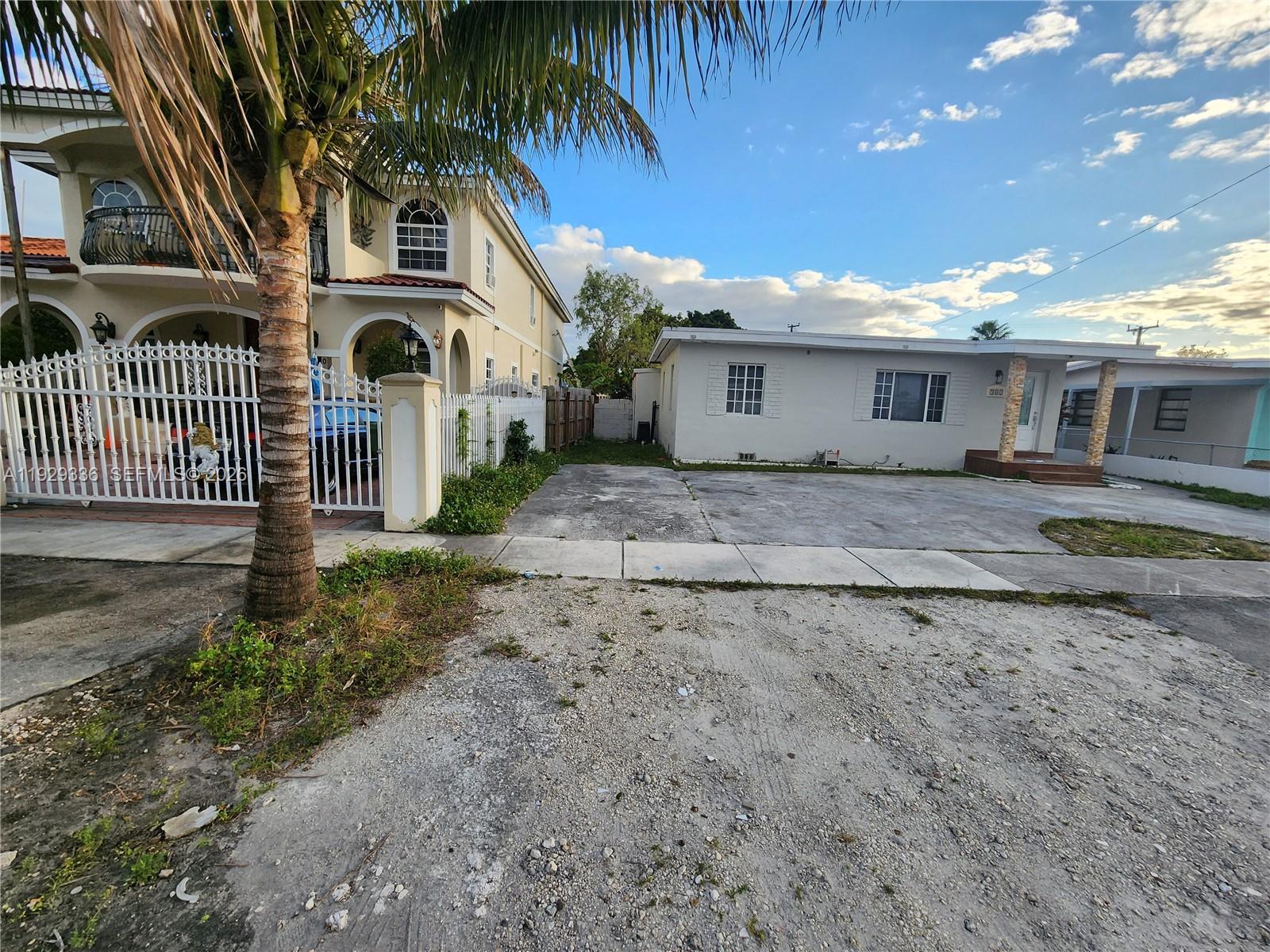 342 East 46th Street, Unit 1 Hialeah, FL 33013 - Photo 24 of 26 a front view of a house with a yard and garage