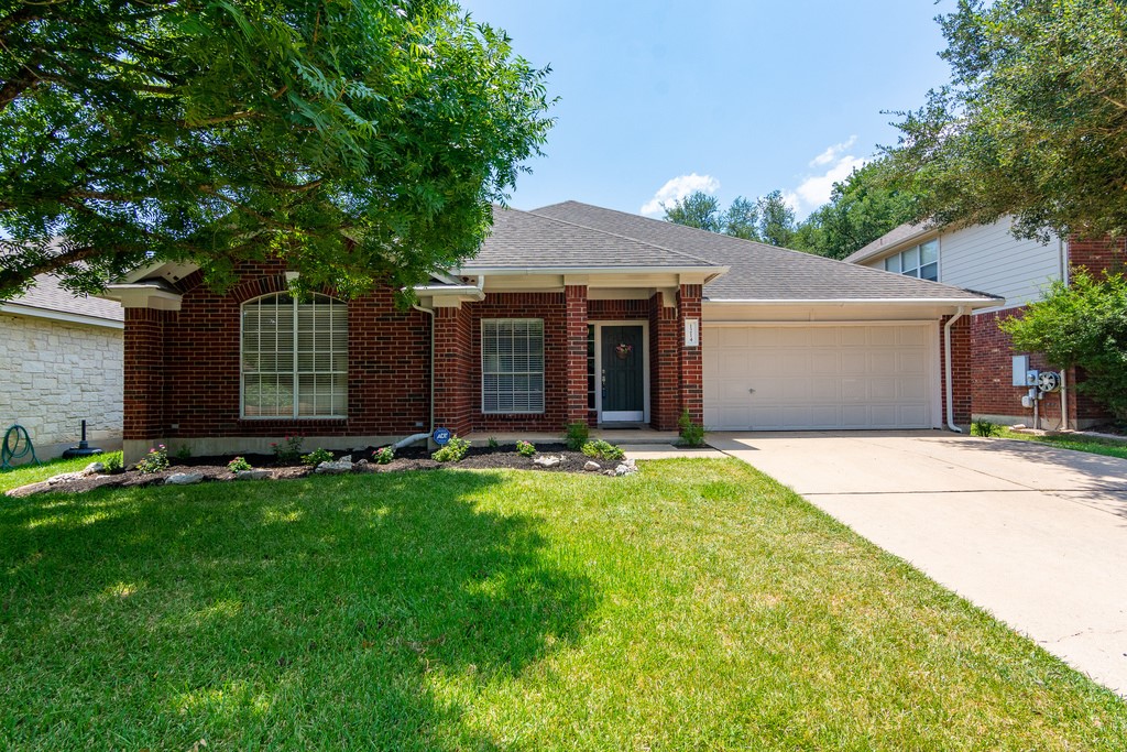 1214 Old Mill Road Cedar Park, TX 78613 - Photo 1 of 1 front view of a house with a yard