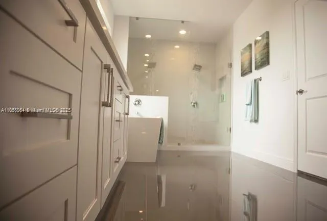 a bathroom with a shower and a sink