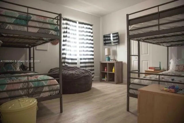 a bedroom with furniture and a large window