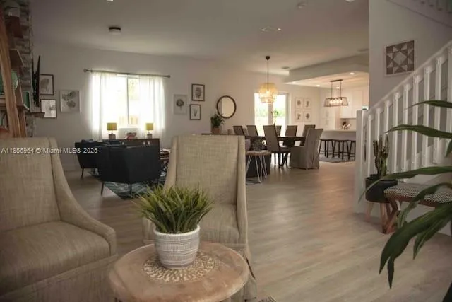 a living room with furniture a dining table and a potted plant