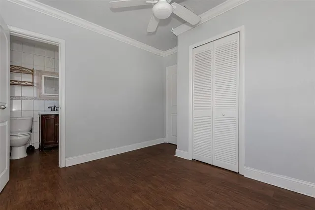 wooden floor in an empty room with a bathroom