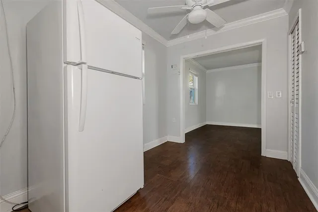 a view of a livingroom with wooden floor and a ceiling fan